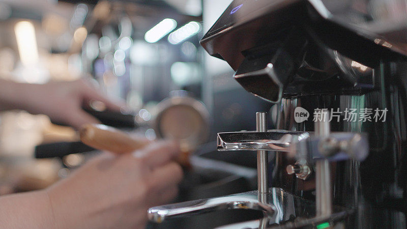 Barista making coffee for customers at the Café. Entrepreneur or employee standing behind the counter ready to serve customers or barista take the order in cafe. Young females business owner or manager working in coffee shop.